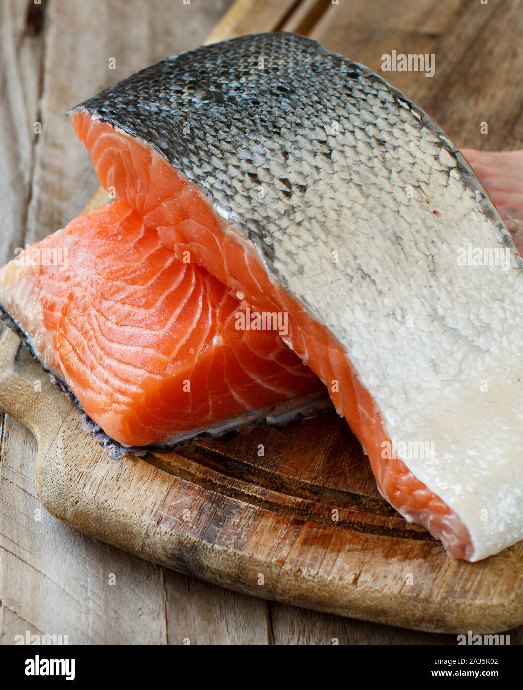 Fresh raw salmon on a wooden cutting board Stock Photo - Alamy