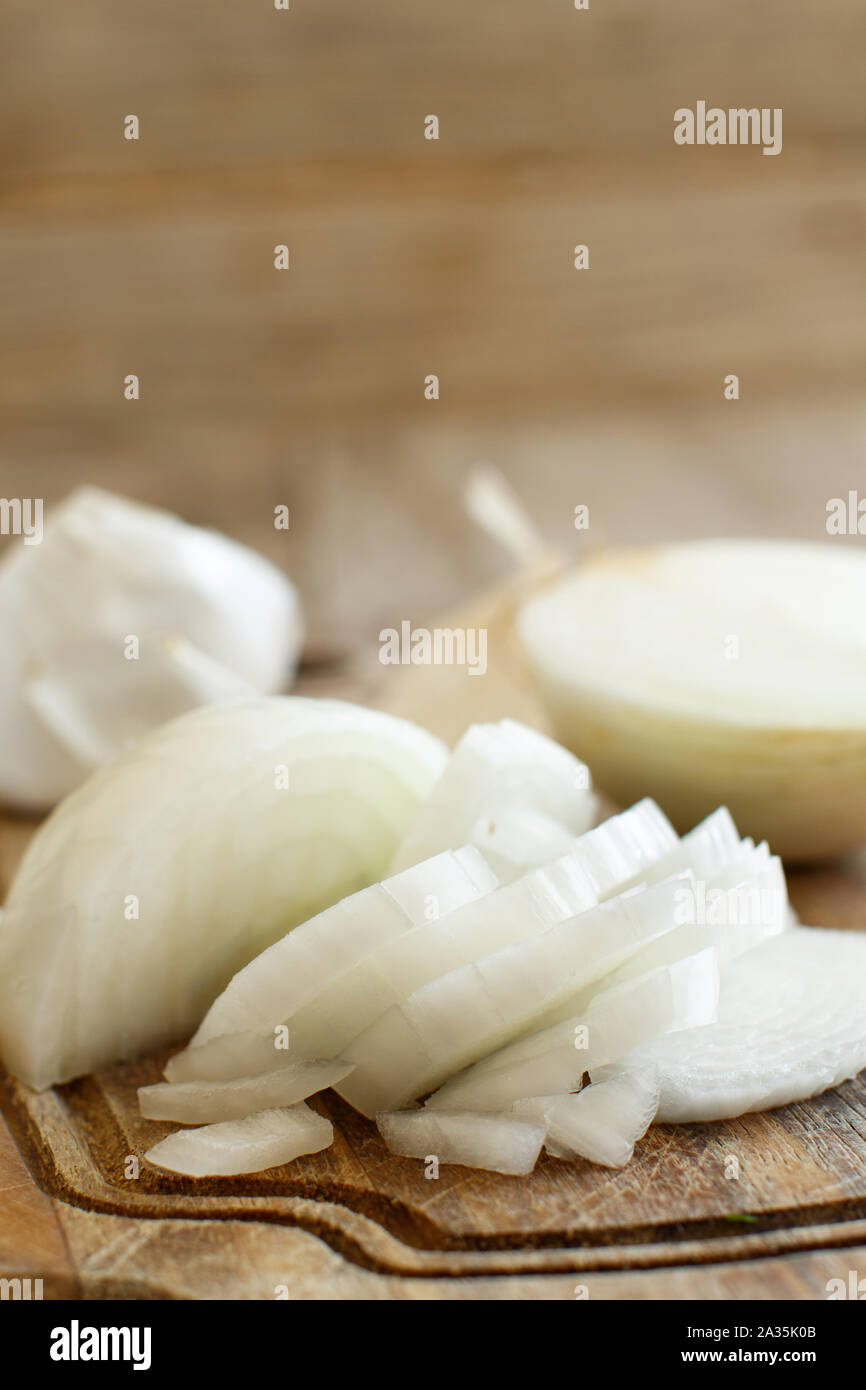 Fresh raw white onion sliced on the cooking board Stock Photo - Alamy