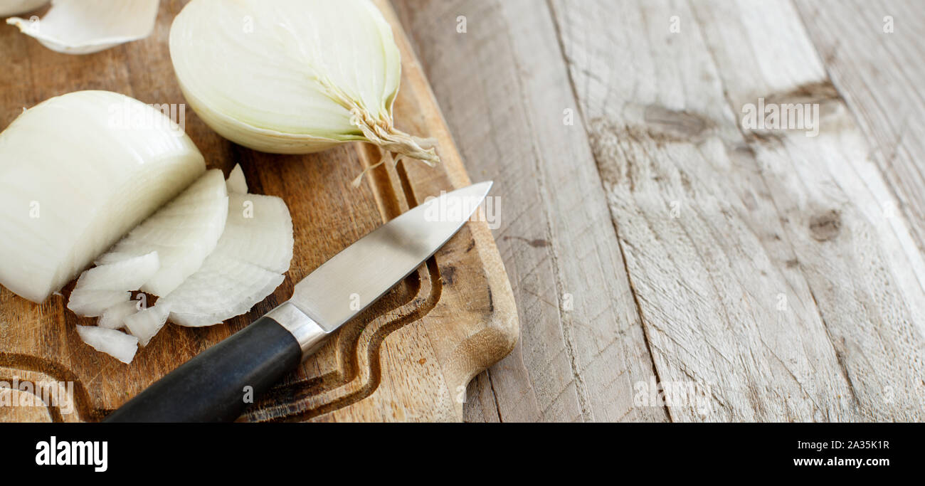 Fresh raw white onion sliced on the cooking board Stock Photo - Alamy