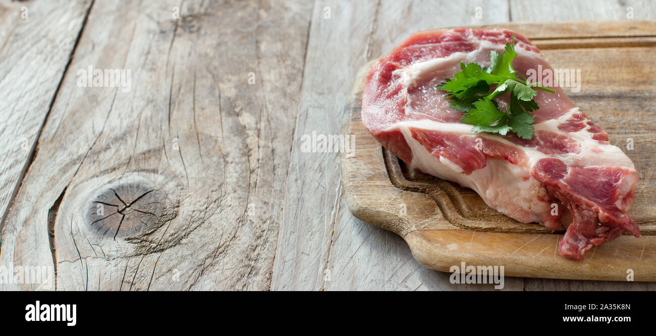 Raw pork steak called capicola with parsley Stock Photo Alamy