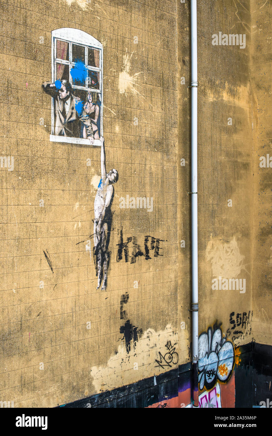 Artwork by Banksy known as Well Hung Lover, Naked Man Hanging From Window, or just Naked Man, on Frogmore Street, Bristol, England, UK. Stock Photo