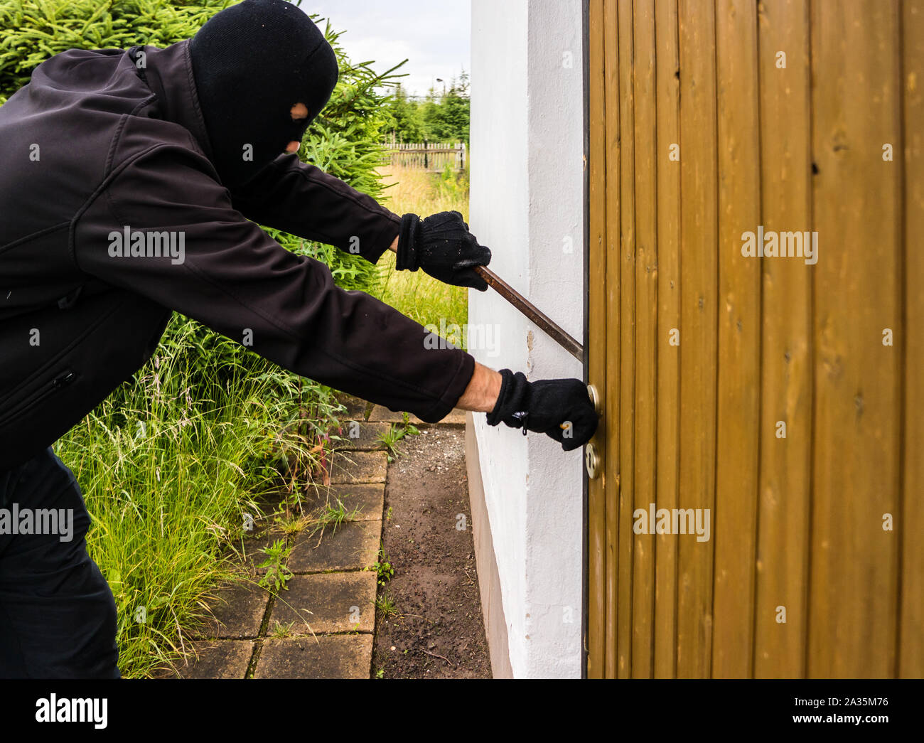 Criminal at break-in Stock Photo