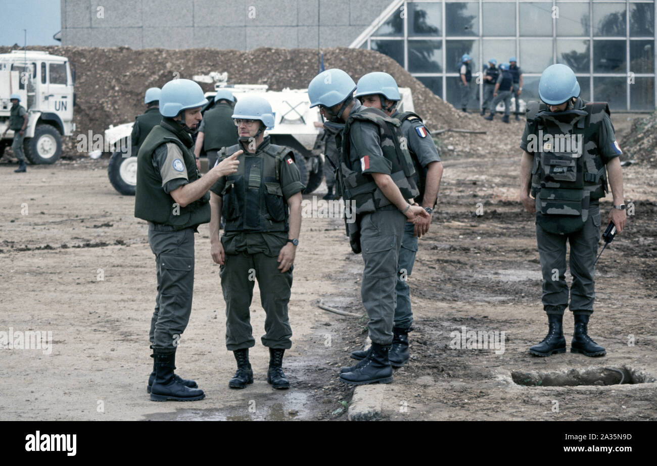 3rd June 1993 During the Siege of Sarajevo: a Canadian soldier talks with French soldiers in the car park at Sarajevo Airport. Stock Photo