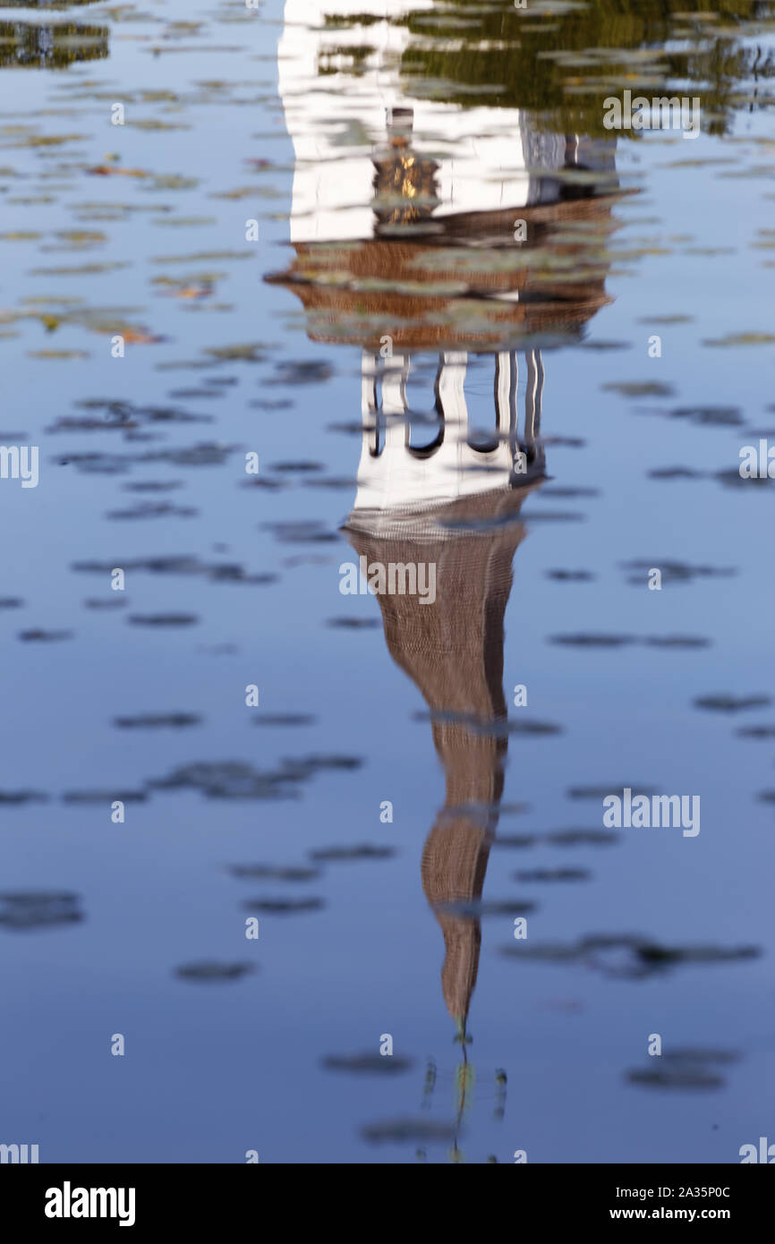 Reflection of a church tower on lakes surface. Stock Photo
