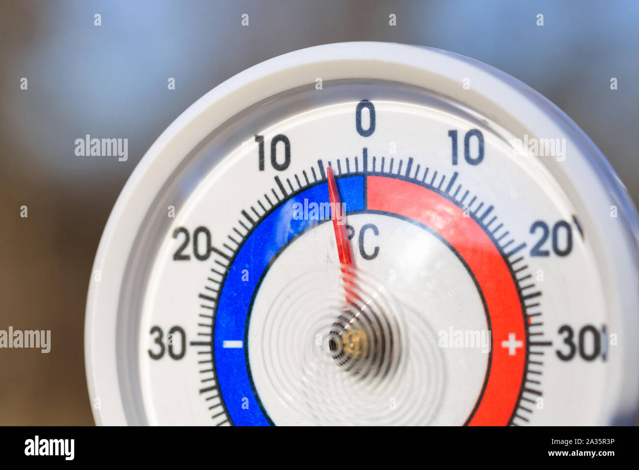 A Celsius thermometer on a window frame shows high temperatures of 43  degrees during an abnormal heat outside., Stock image