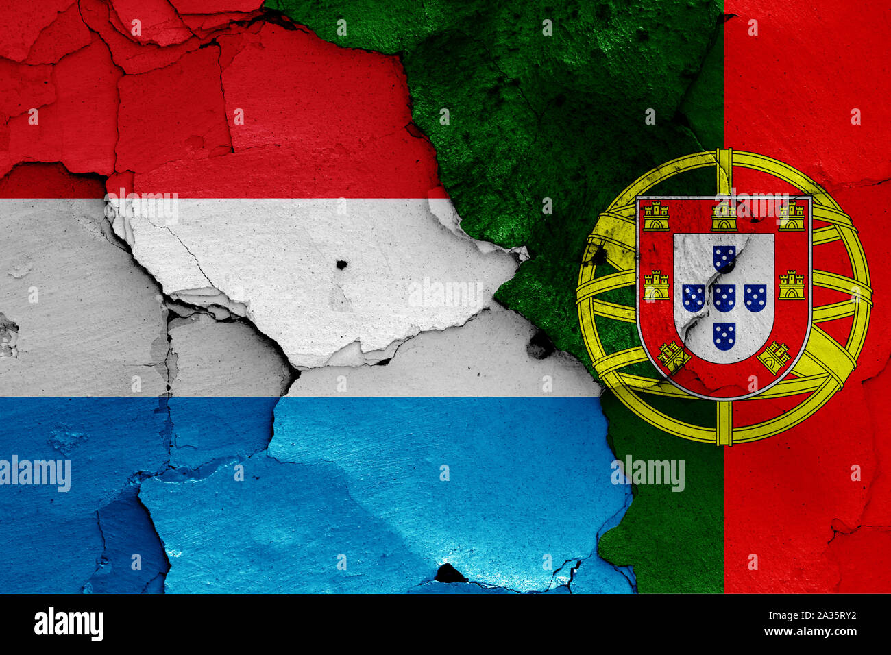 flags of Luxembourg and Portugal painted on cracked wall Stock Photo