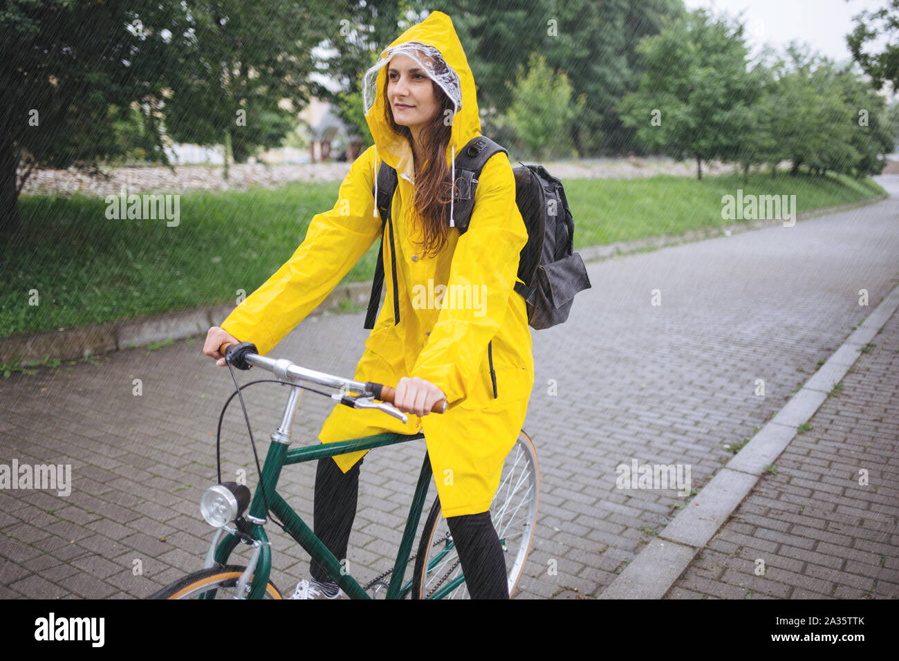 Cycling in the rain Stock Photo Alamy