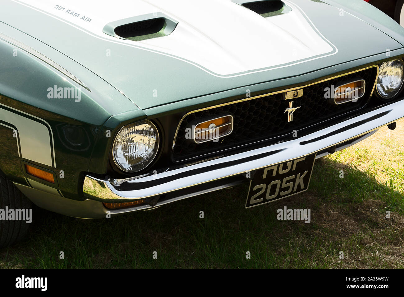 The front of a green 1971 Ford Mustang on display at a car show Stock Photo