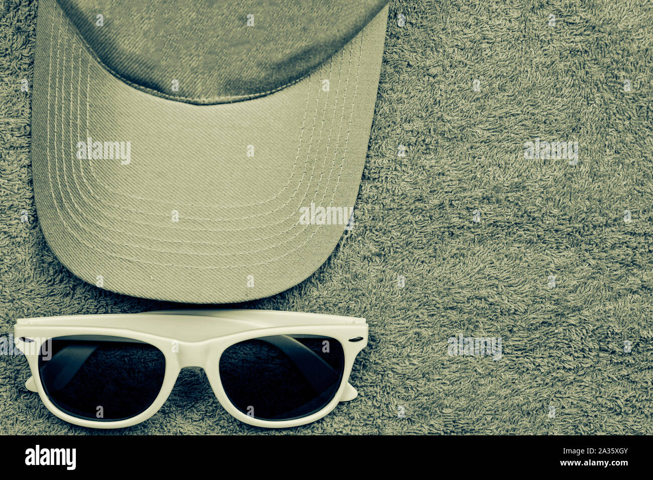 Baseball caps and sunglasses lie on a towel Stock Photo Alamy