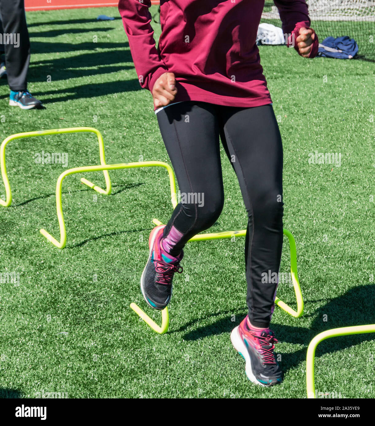 Athletes are performing sprinting drills by driving their foot down