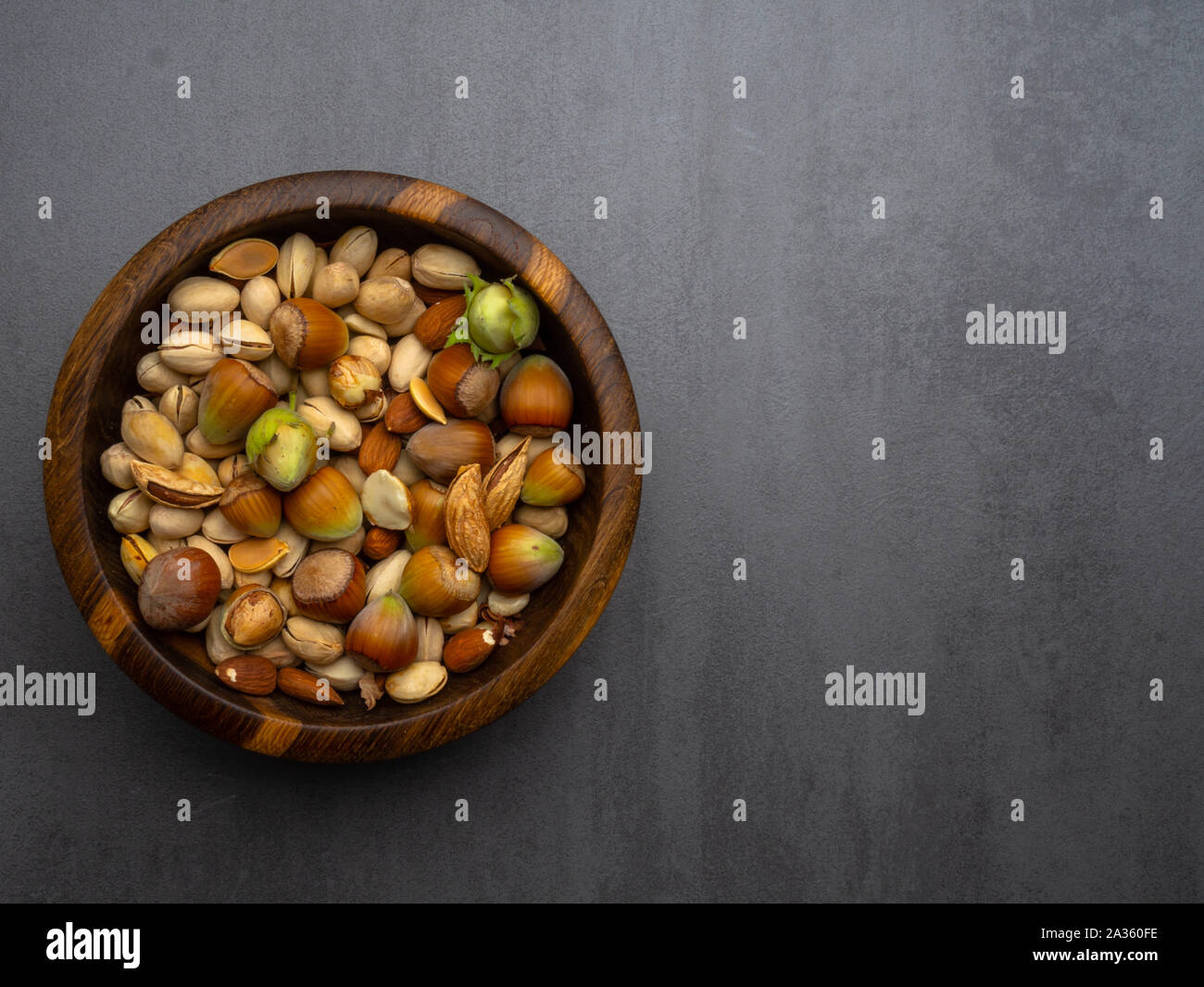 Assorted nuts and pumpkin seeds in wooden bowl, vitamin E rich food, vegan food, snack Stock Photo
