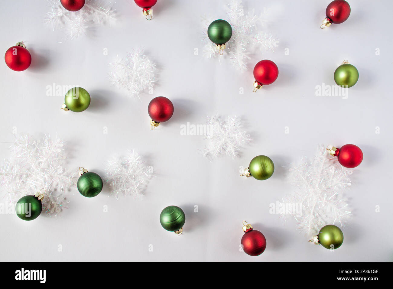 Decorative snow and christmas balls of red and green colors. Christmas concept flat lay Stock Photo