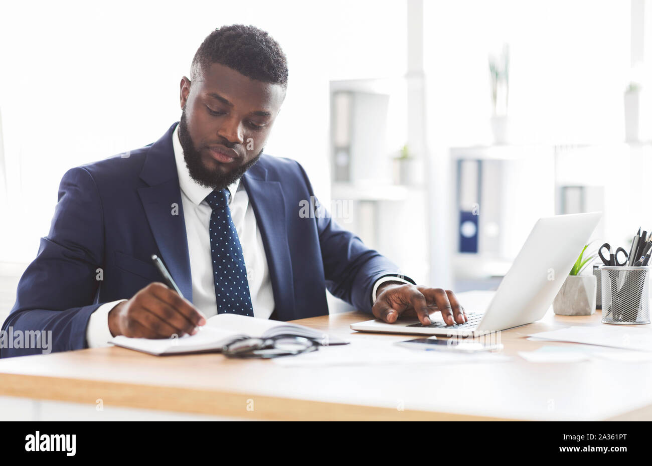 Successful black businessman working hard in office Stock Photo