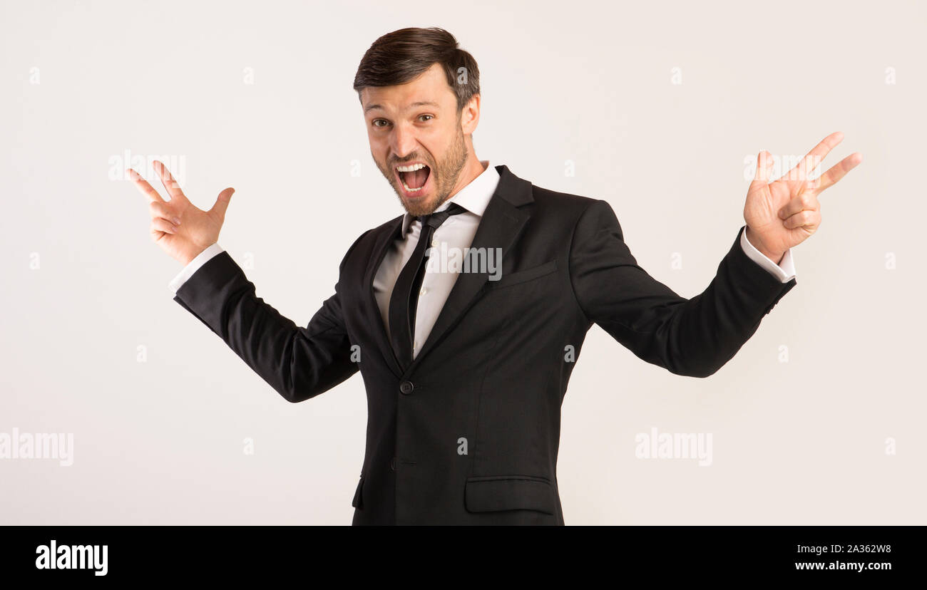 Excited Man Shouting Spreading Hands Standing On White Background Stock Photo
