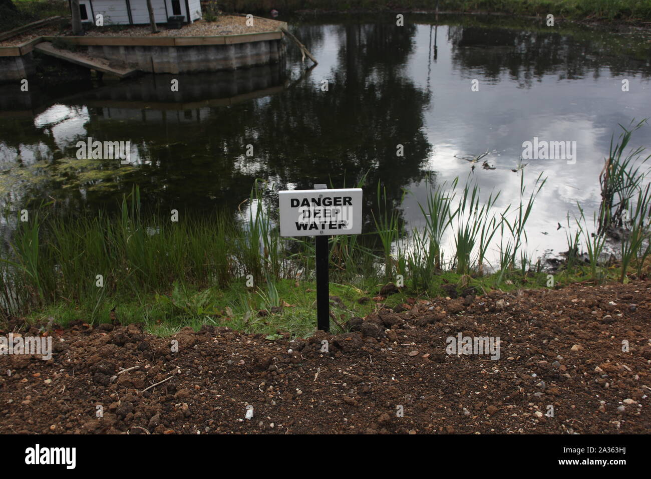 Danger Deep Water sign at a pond in Battlesbridge, Essex, Britain. Stock Photo