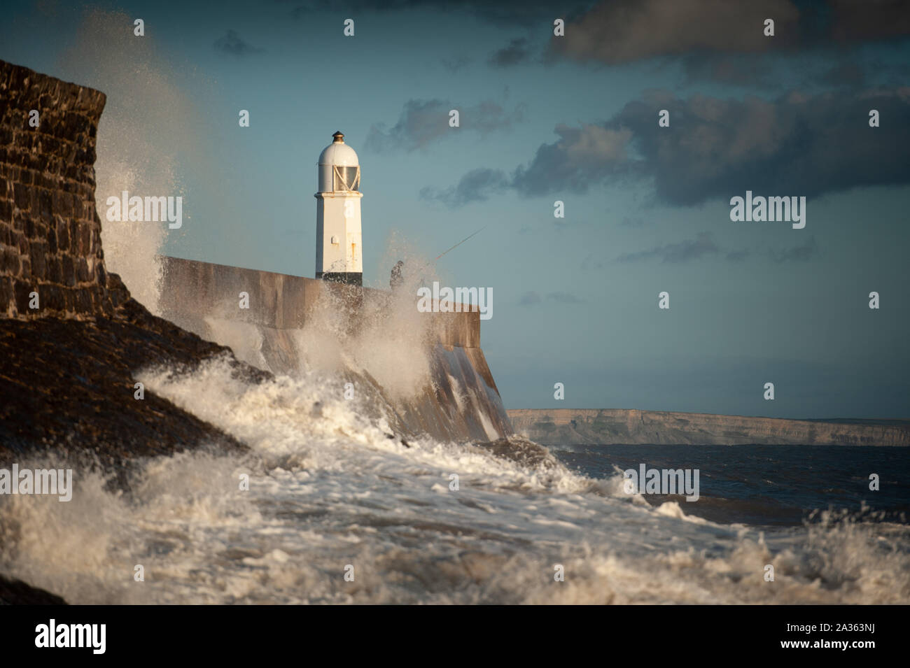 Porthcawl, County Borough of Bridgend, Wales, UK. 29th September 2019. Anglers brave the crashing waves at Porthcawl Lighthouse in south Wales. Stock Photo