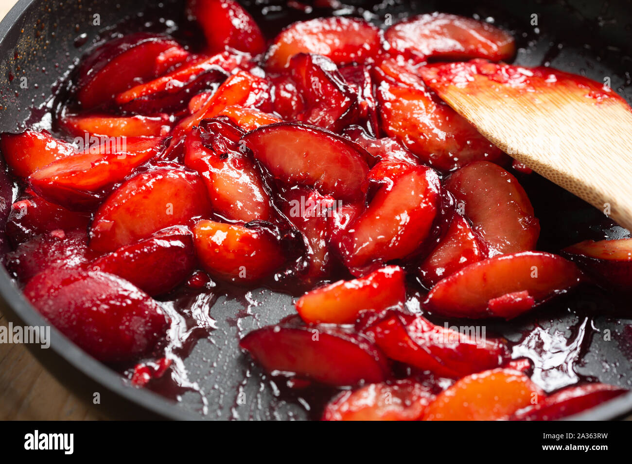 cooking fresh plums in a pan Stock Photo