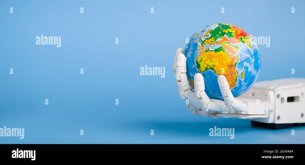 Globe in robot hand, blue panorama background Stock Photo