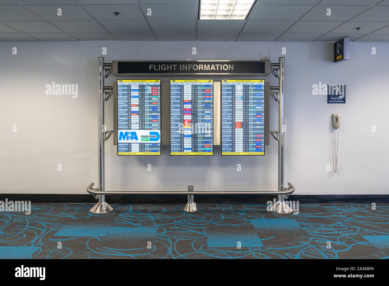 Miami, USA - September 11, 2019: Monitor at Miami International Airport lists scheduled departing flights Stock Photo