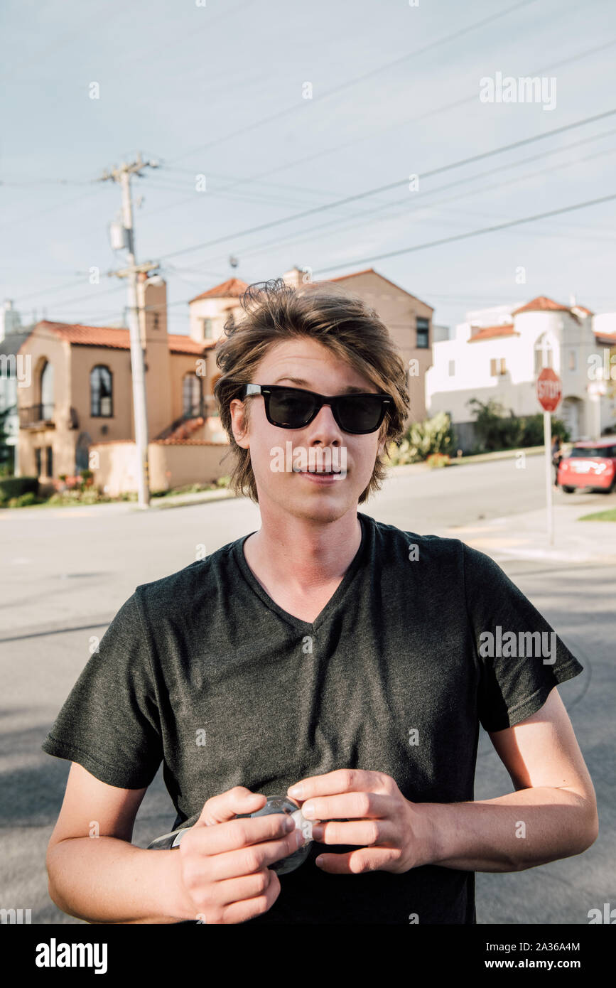 Young Man Skating in the Street in a Residential neighborhood Stock Photo