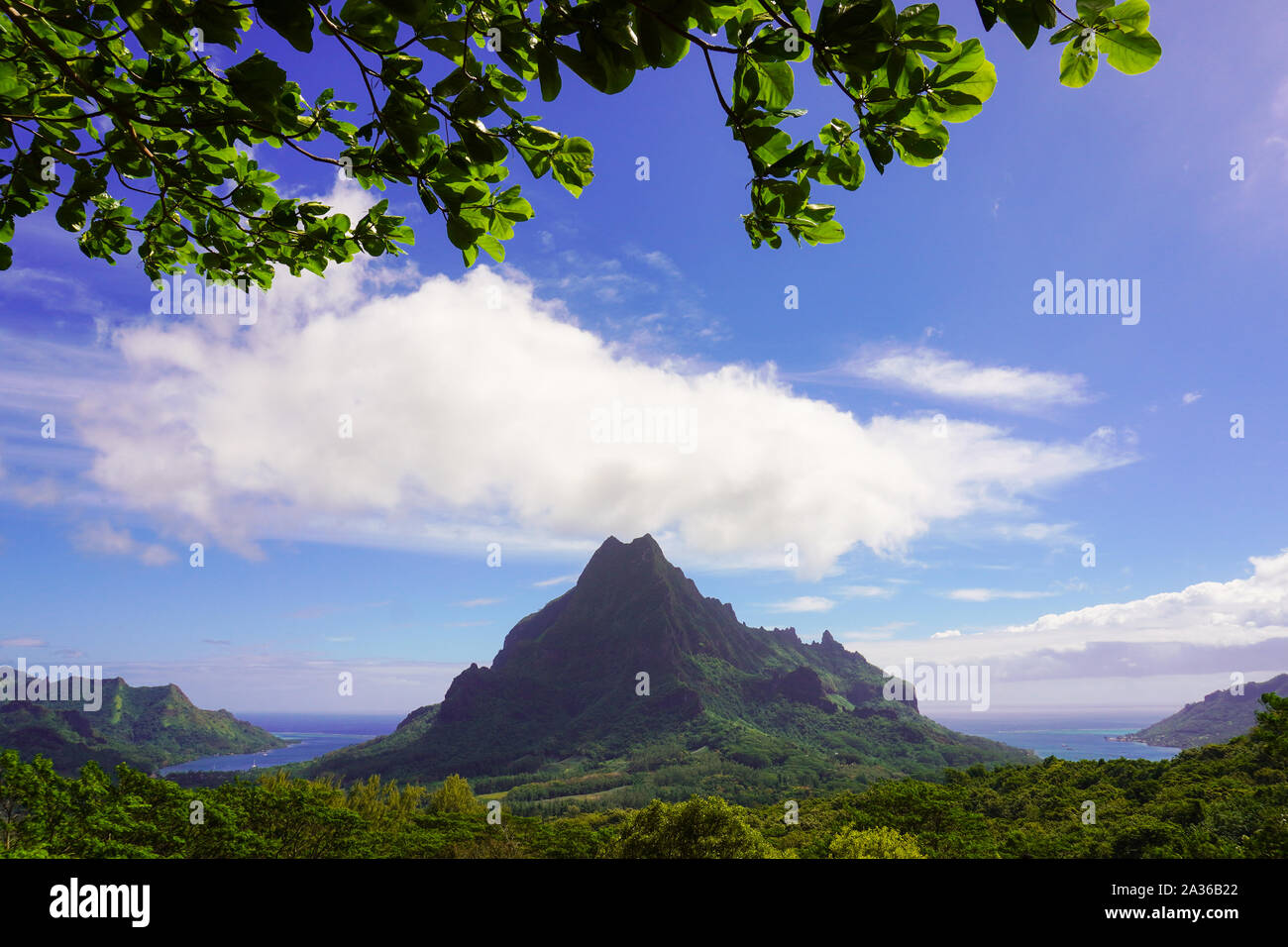 Landscape of Mt Rotui volcano rising above two bays on the island of Moorea in French Polynesia Stock Photo