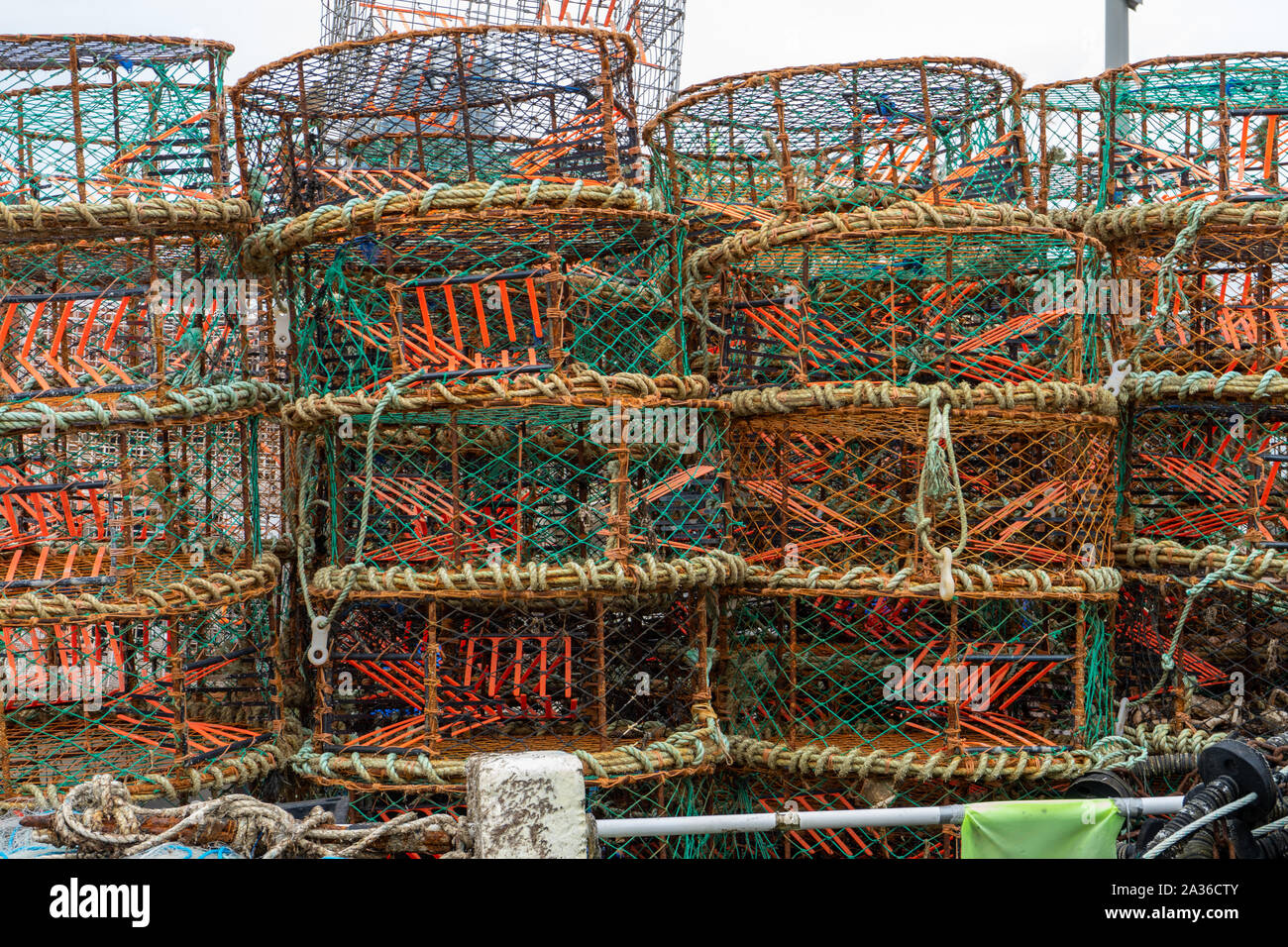 lobster pots and crab pots stacked ready to take fishing Stock Photo