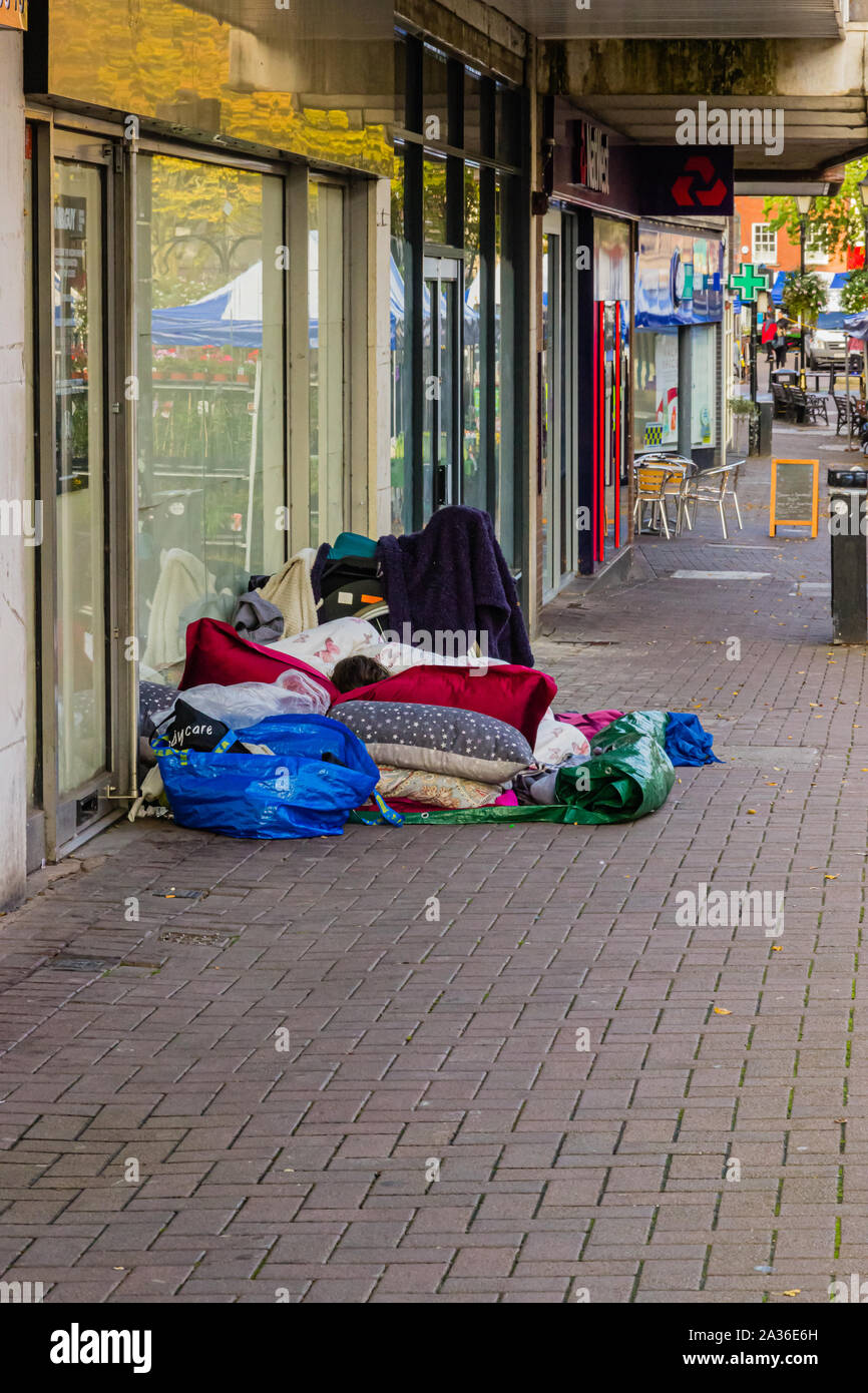 Homeless asleep outside an abandoned shop sum up economic down turn. Nuneaton, UK, 28th September 2019 Stock Photo