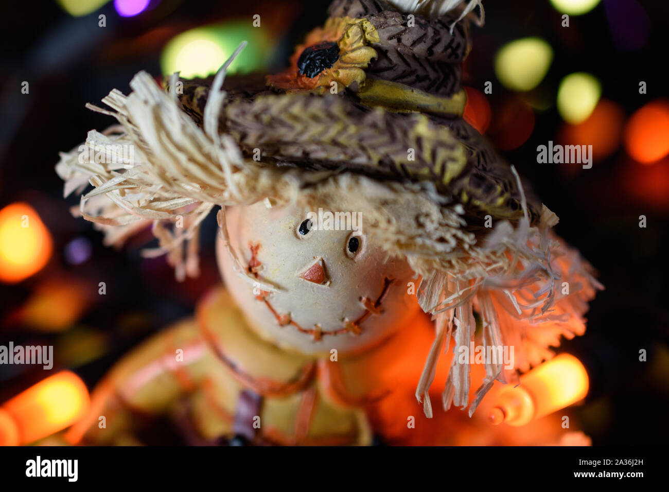 Closeup of Adorable Scarecrow Face illuminated by Halloween Led Lights Stock Photo