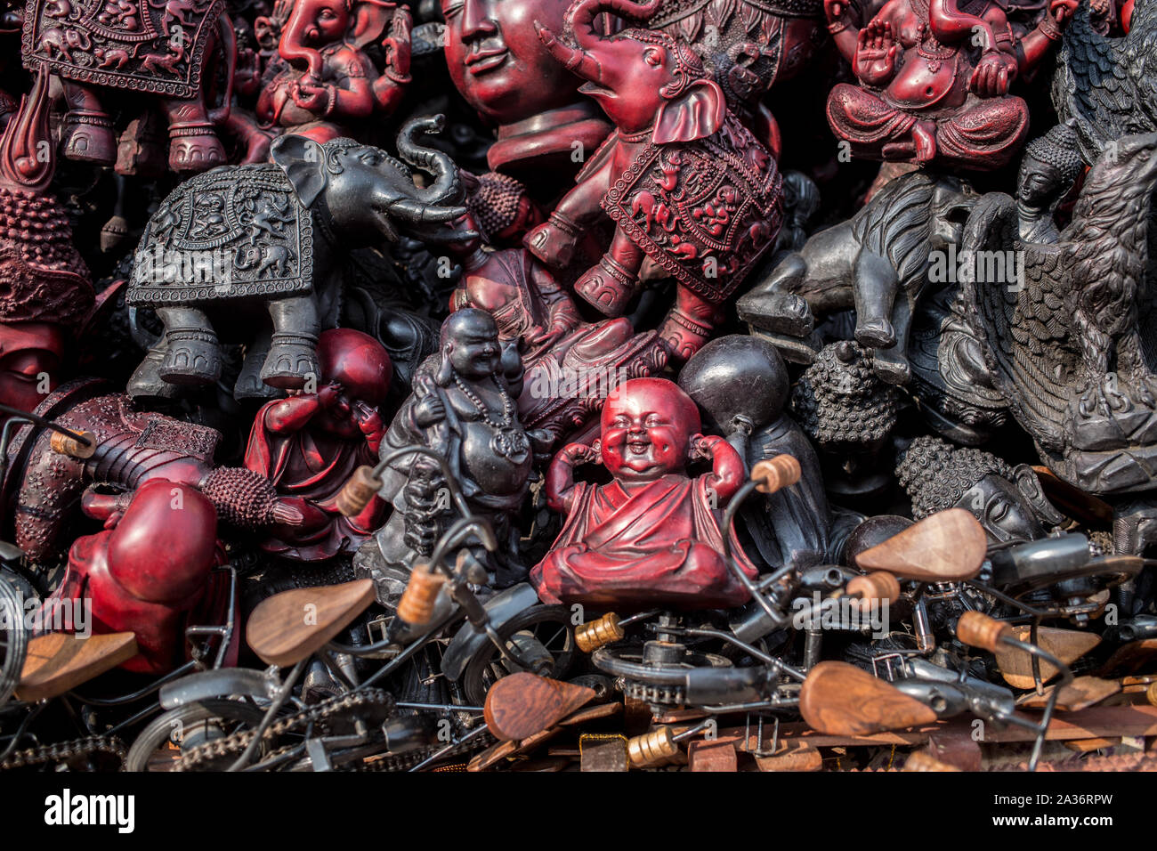 A pile of old antique religious statues including Buddha Stock Photo