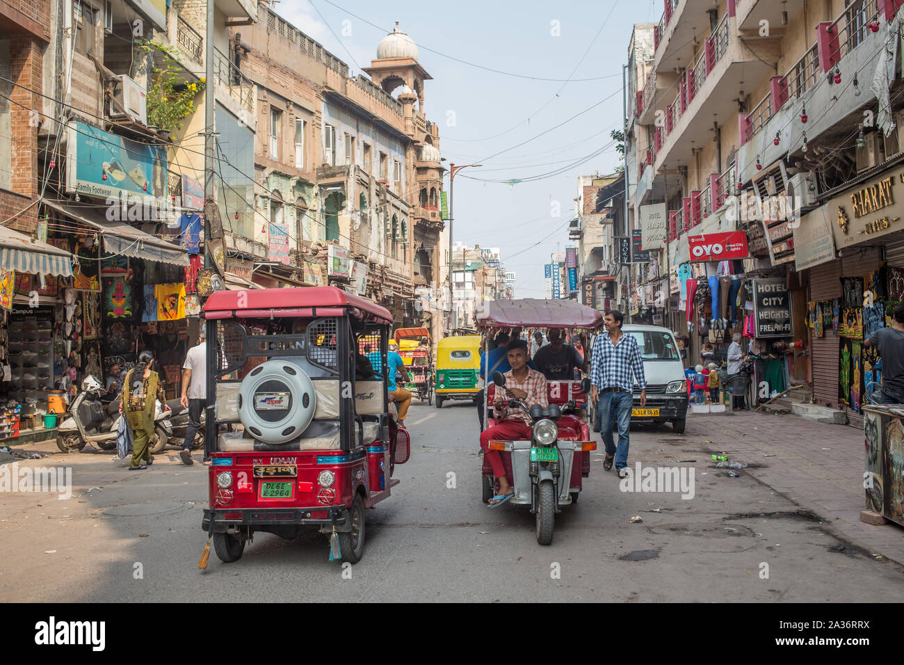 A view of electric rickshaws on a road in downtown New Delhi. Stock Photo