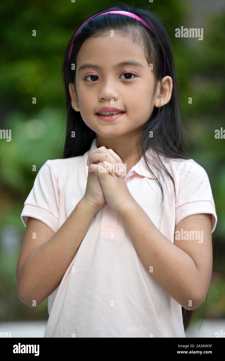 A Praying Petite Filipina Child Stock Photo