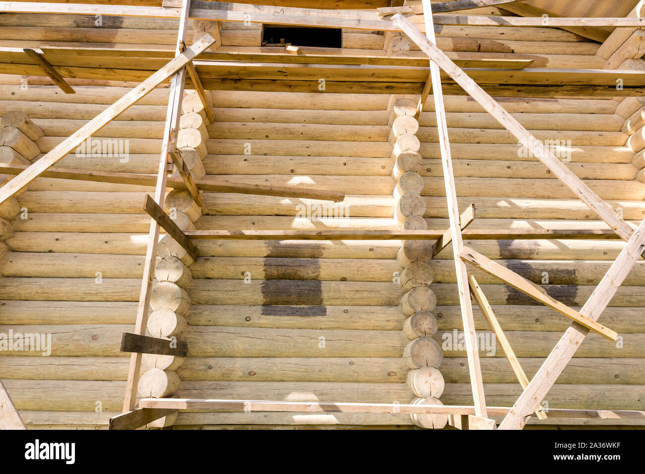 Fragment of the construction of a wooden house made of round logs ...