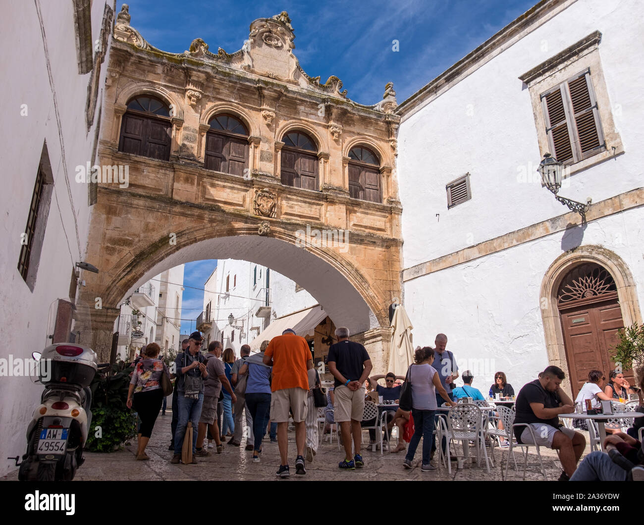 People wandering and enjoying the old town of Ostuni, Italy Stock Photo