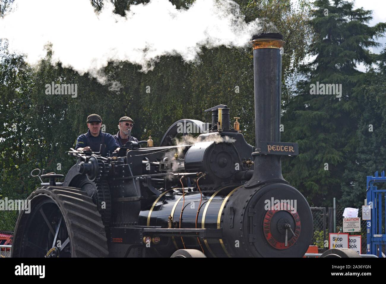 Two men drinving a Wallis' steam traction engine on display at Tyseley Railway Centre, Birmingham, UK Stock Photo