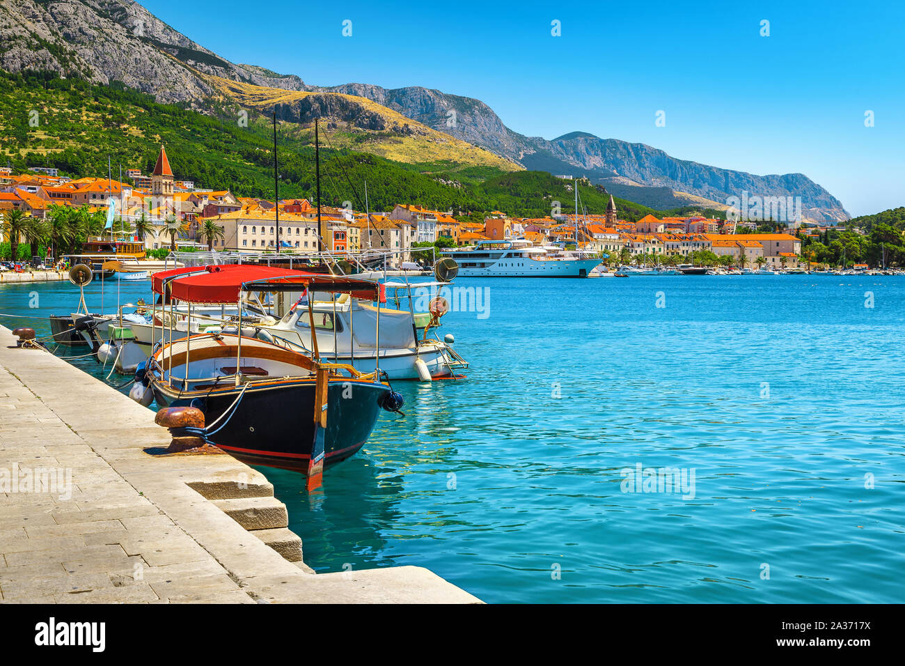 Amazing touristic and travel location. Adriatic resort with picturesque harbor and touristic boats, Makarska riviera, Dalmatia, Croatia, Europe Stock Photo