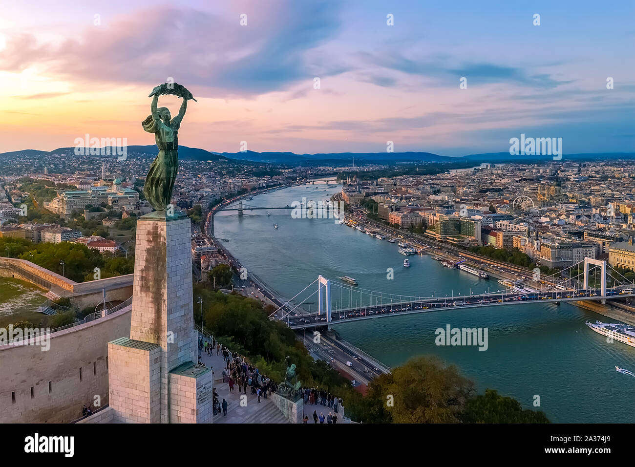Budapest cityscapes form Gellert Hill. Amazing sunset in the background. Included the Danube river, historical bridges, Budapest dwontown, Gellrt squa Stock Photo