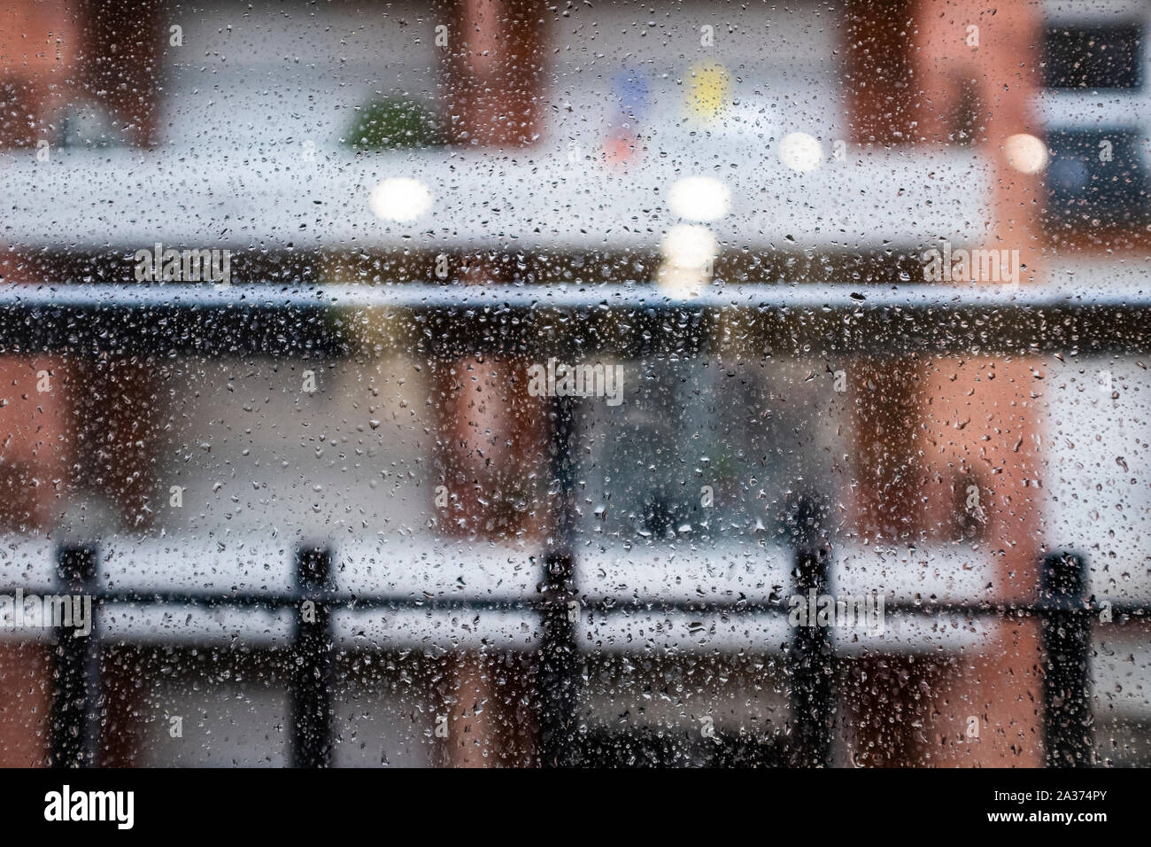 Many raindrops on a window glass on a blurry background Stock Photo