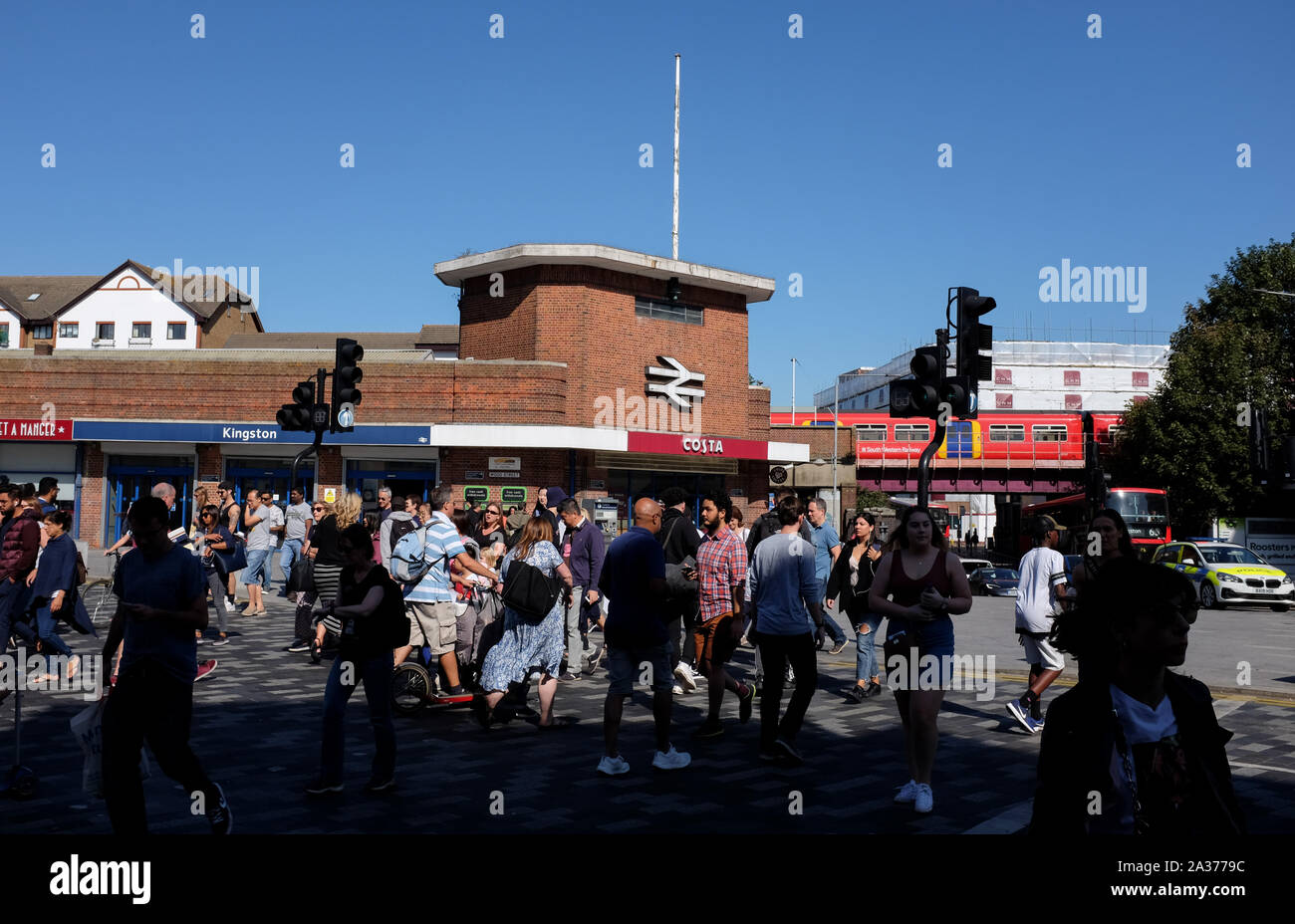 Kingston Upon Thames South West London UK - Crowds crossing road outside Kingston Railway Station Stock Photo