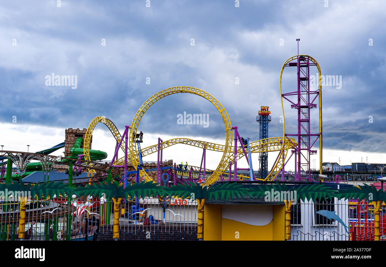 Southend On Sea Essex UK - Adventure Island theme park on the seafront with maintenance staff at work on roller coaster ride on dull Autumn day Stock Photo