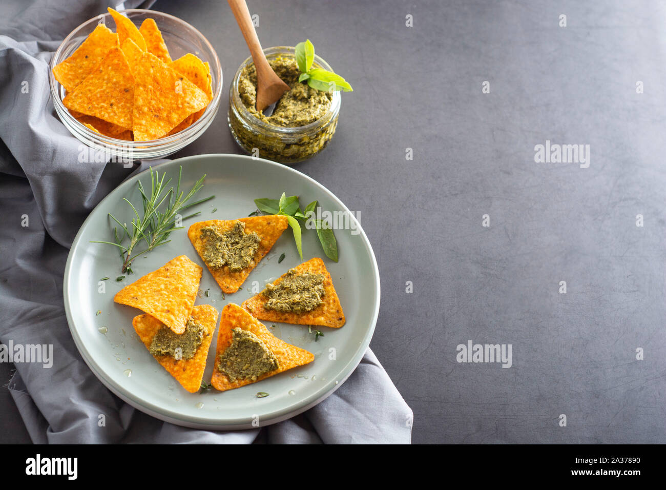 Nachos chips or corn mexican chips with guacamole, pesto pasta healthy food snack isolated copy space Stock Photo