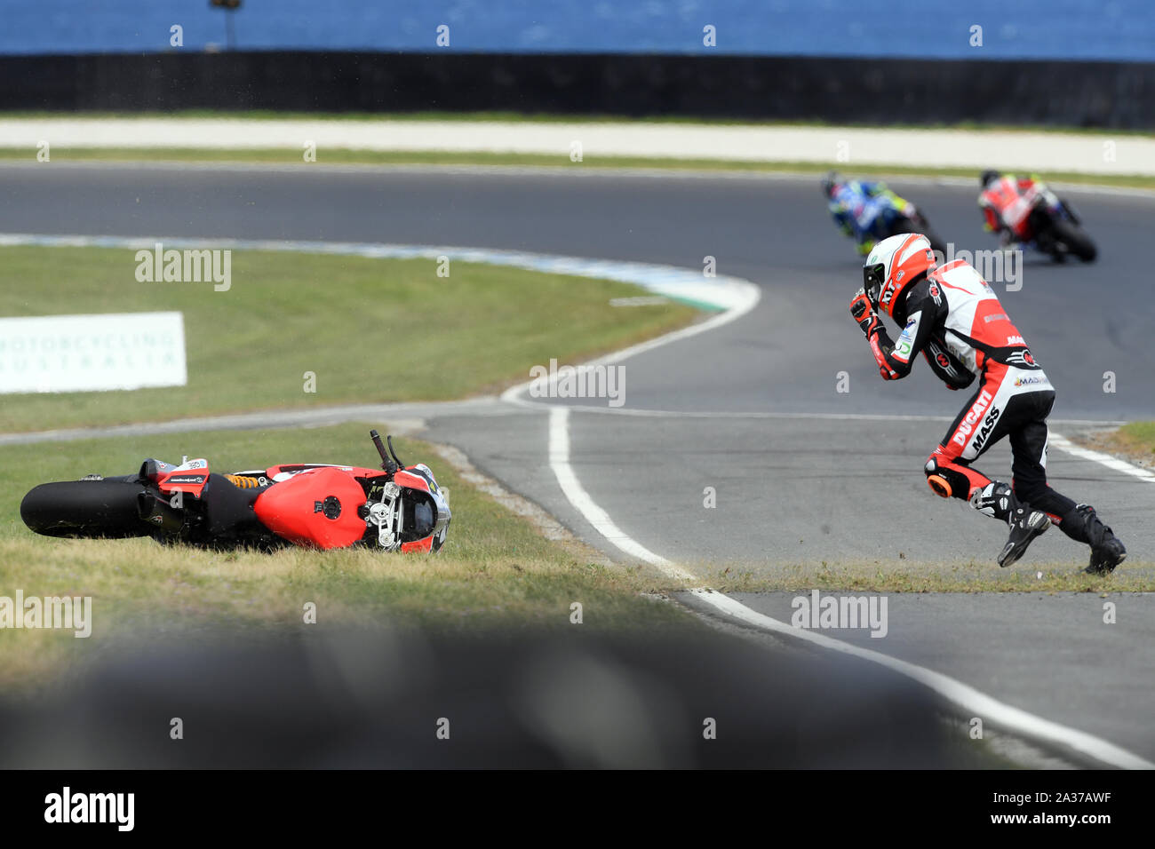 Ducati Mike rider Jones runs to pick up his bike after crashing out. Australian Superbike Championship Round 6 - Race 2 Phillip Island Stock Photo