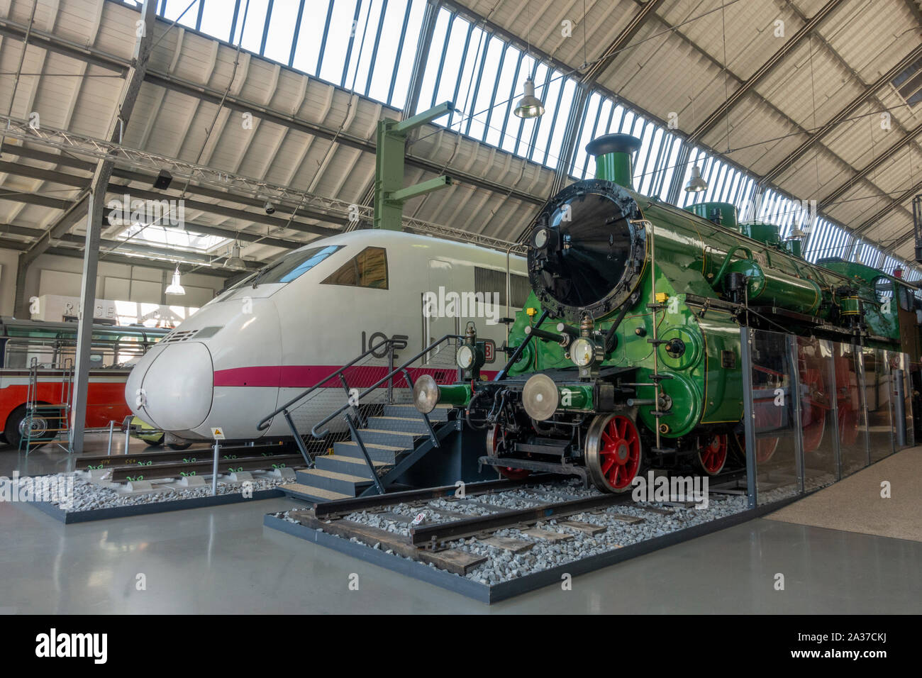 A J. A. Maffei Class S 3/6 steam locomotive (1912) and modern ICE-V (experimental) train side by side in theGerman Transport Museum, Munich, Germany. Stock Photo