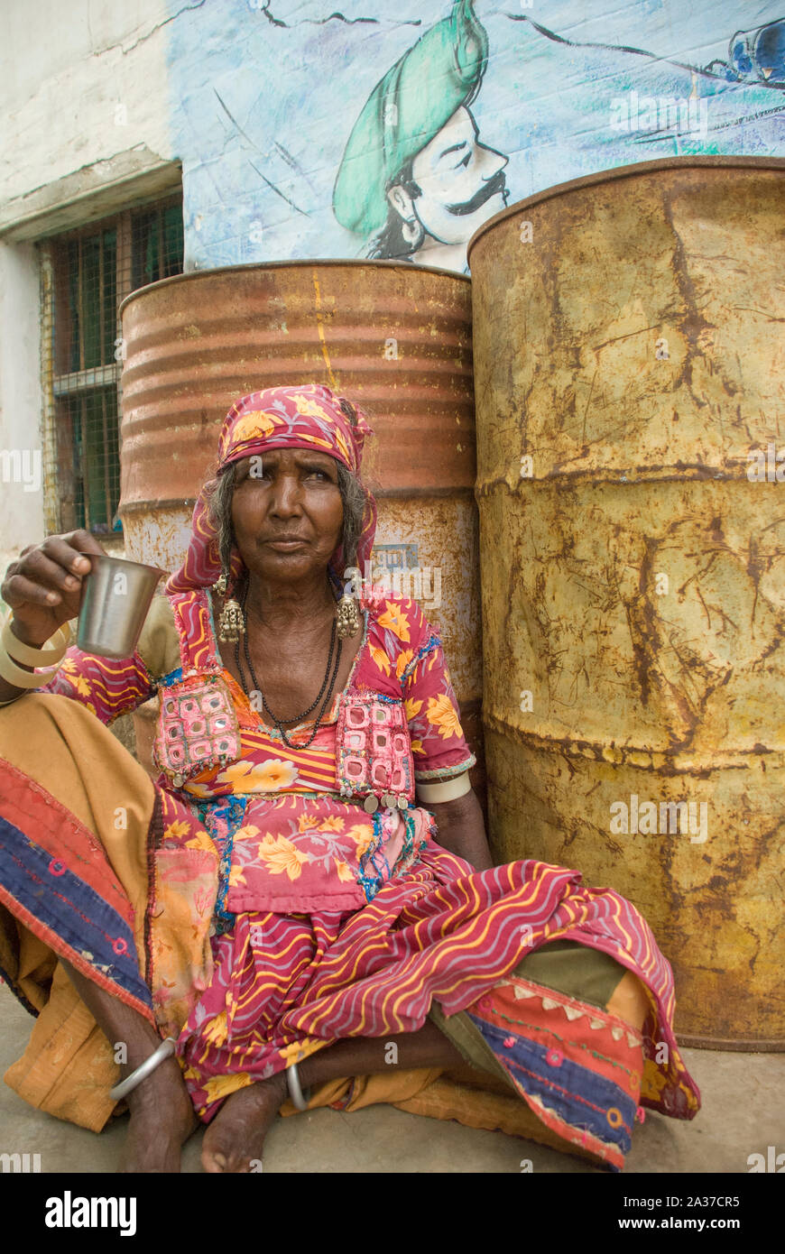 Hampi, Karnataka, India - September 26, 2010: Banjara woman relaxing drinking masala chai Stock Photo