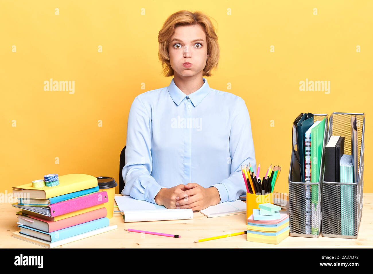 funny woman having fun at workplace, close up portrait, isolated yellow ...