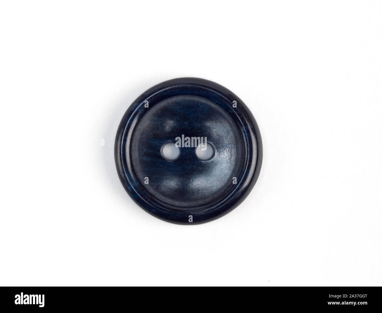 Dark blue plastic button on white background Stock Photo