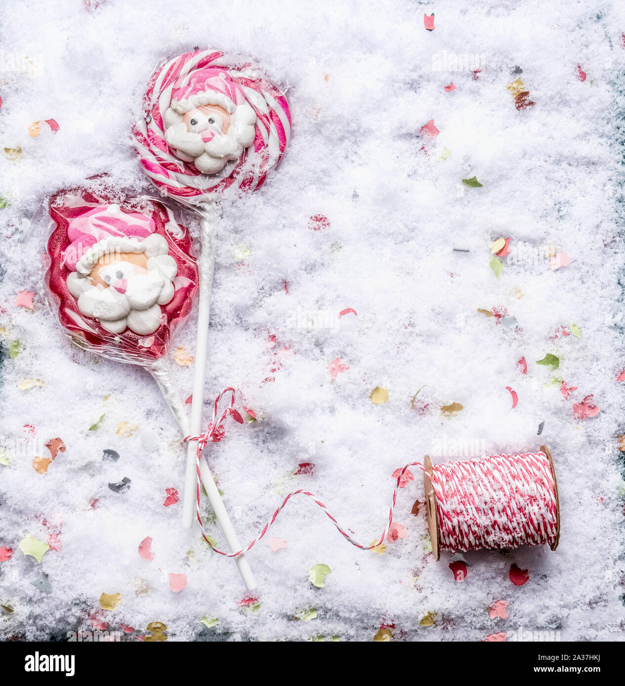 Christmas candy lollipops with Santa on snow, top view. Copy space Stock Photo