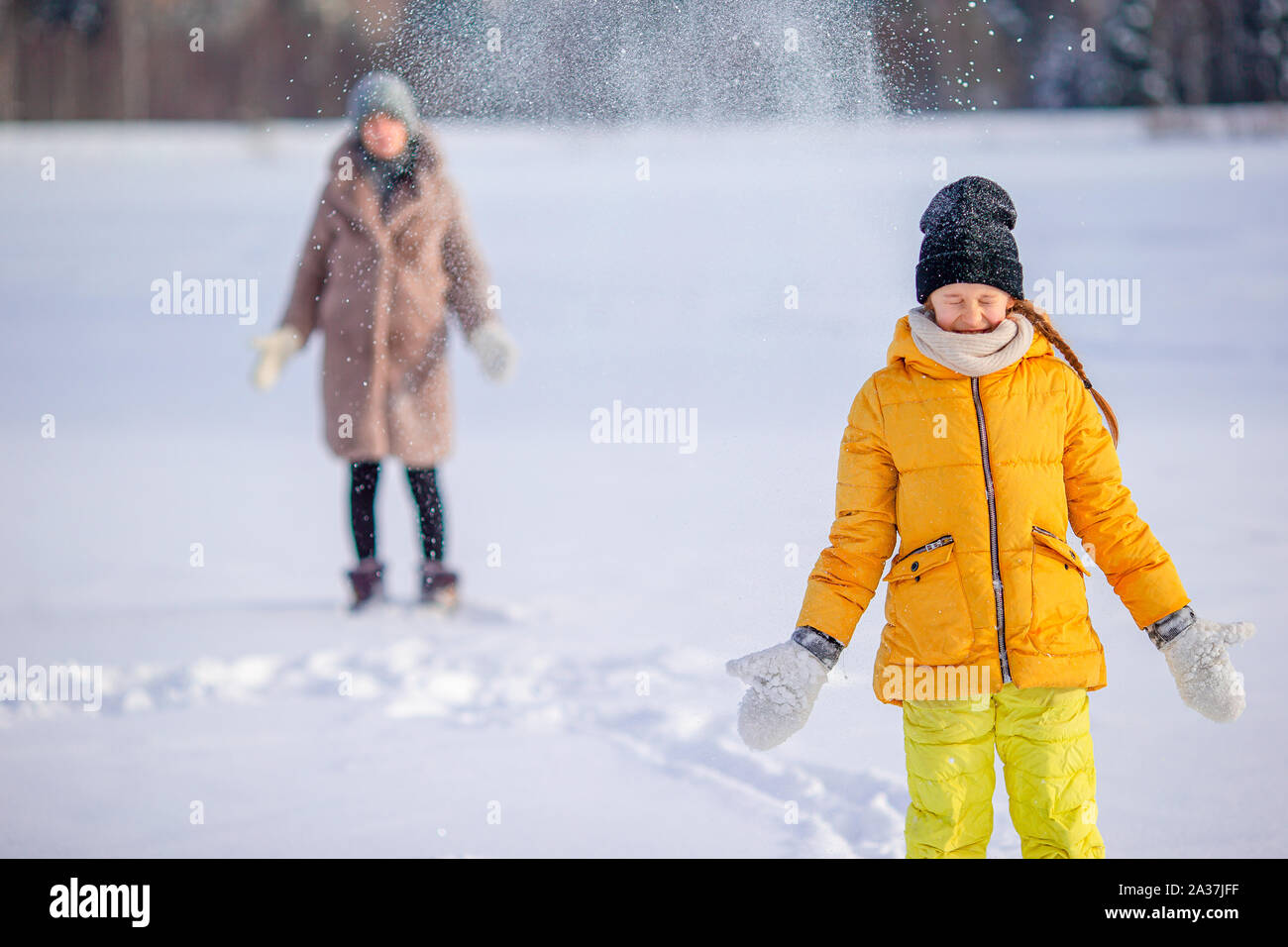 Happy family having fun outdoors in winter with snow Stock Photo - Alamy