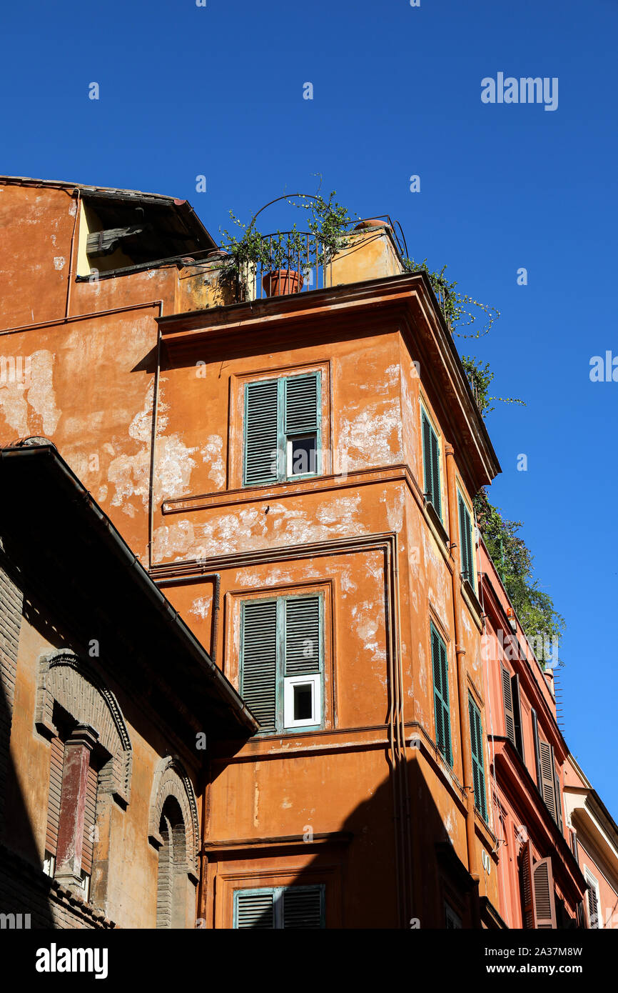 Upper floors of residential building against clear blue sky in Trastevere district, Rome, Italy Stock Photo