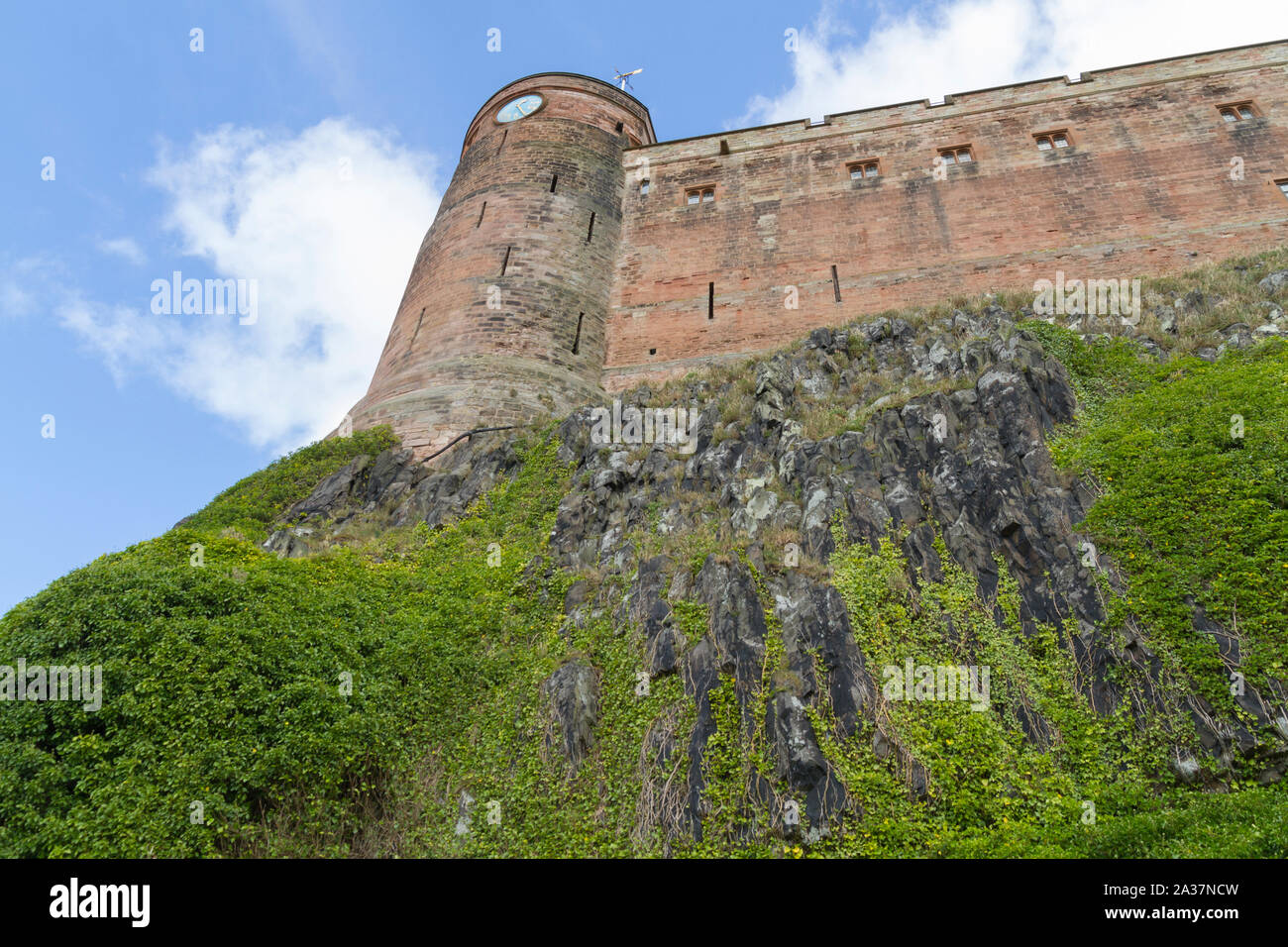 The steep denfensive Bamburgh Castle walls in Northumberland UK Stock Photo