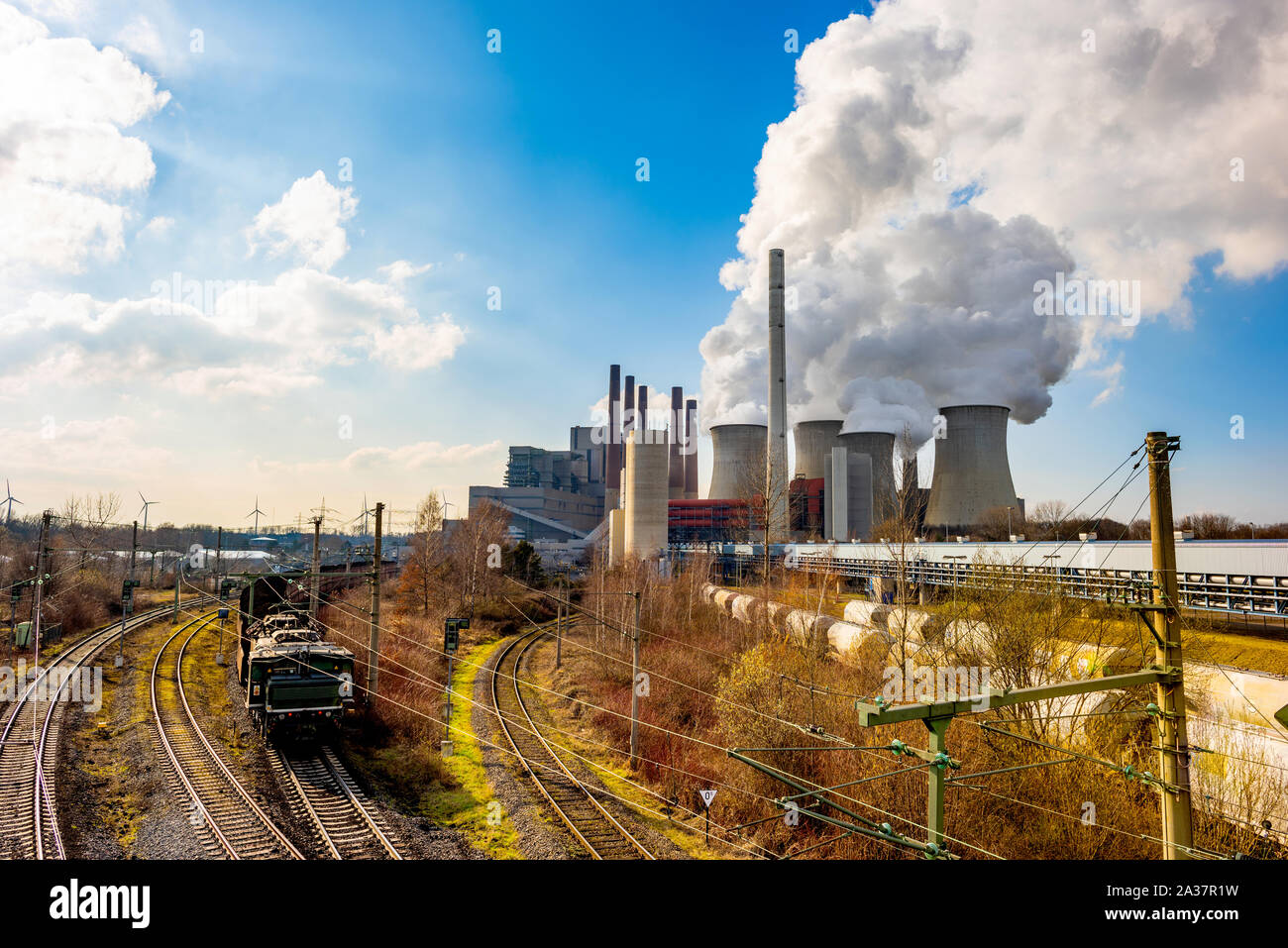Coal fired power plant with smoking cooling towers Stock Photo